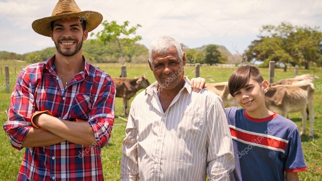 Three Generations Family Portrait Of Farmers In Farm