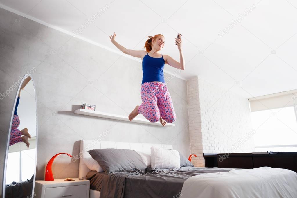 Good News For Happy Young Woman Girl Jumping On Bed