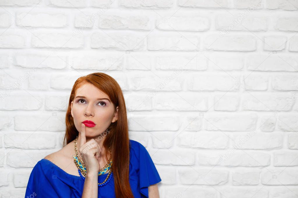 Facial Expressions Of Young Redhead Woman On Brick Wall