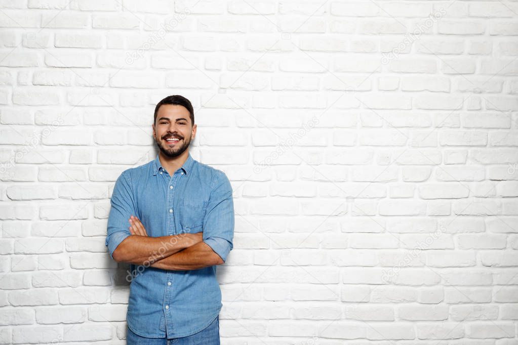 Facial Expressions Of Young Beard Man On Brick Wall