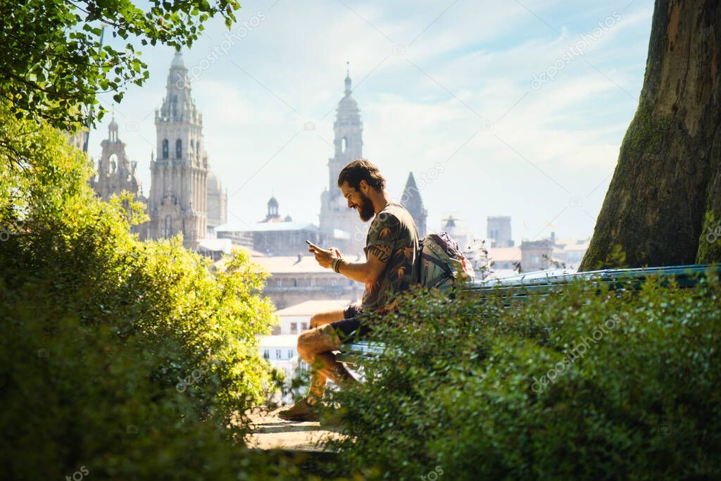 Young Man On Pilgrimage At Santiago De Compostela With Phone