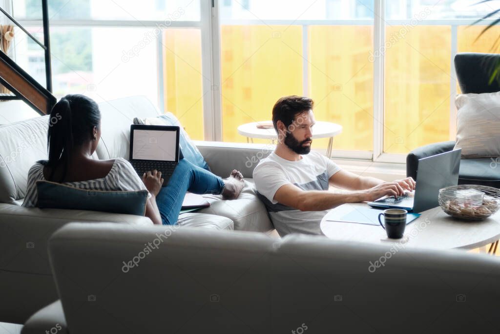 Couple Working And Playing With Laptop Computer At Home