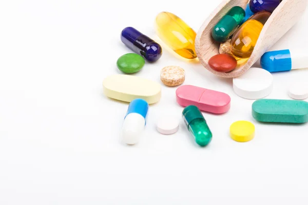 Különböző színű tabletta és kapszula fa dispencer — Stock Fotó