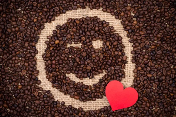 Coffee beans with red heart and winking smiley face