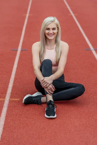 A Young Athletic College Athlete Prepares For A Track Meet At A University