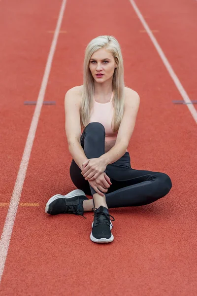 A Young Athletic College Athlete Prepares For A Track Meet At A University