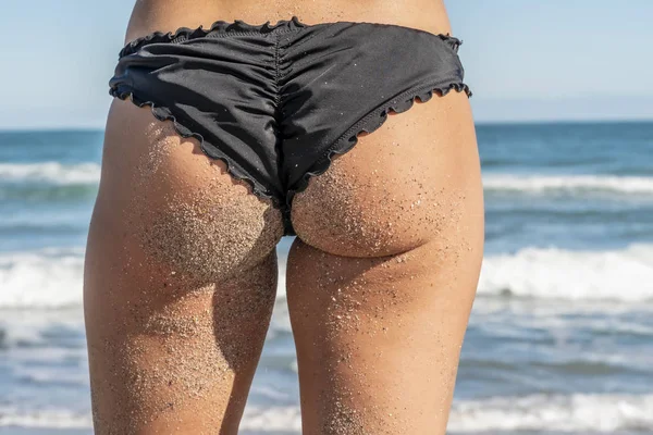 Hermosa modelo de bikini posando en un entorno de playa — Foto de Stock
