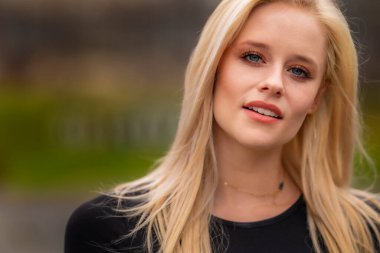 Sarışın bir model, açık havada bahar gününün tadını çıkarıyor. 