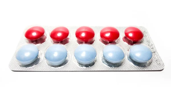 Multicolored tablets in transparent packaging. Medical products to maintain good health and well-being.