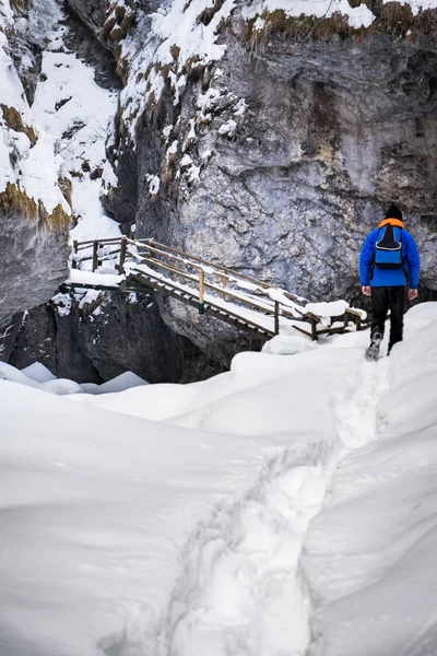 Mann wandert durch Tiefschnee zur Treppe in der Bärenschüetzklamm — Stockfoto