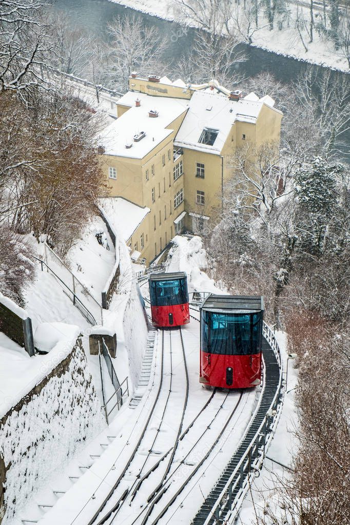 Red funicular railway cable car on hill Schlossberg in Graz