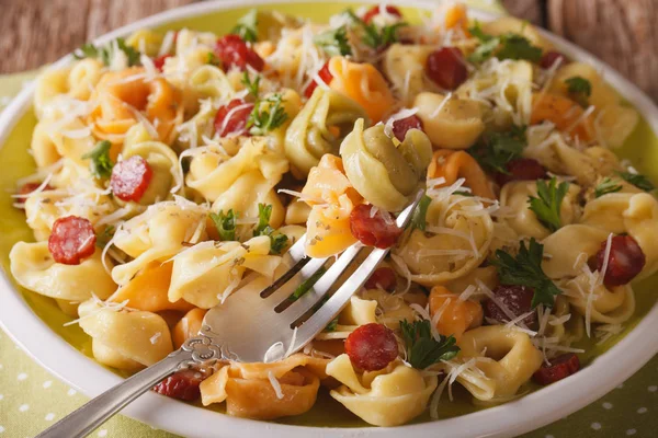 Colored Tortellini with parmesan cheese and sausages close-up. h — Stock Photo, Image