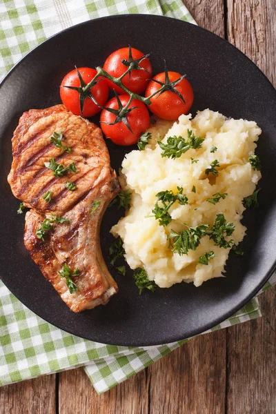 Grilled pork T-bone steak garnished with mashed potatoes close-u — Stock Photo, Image