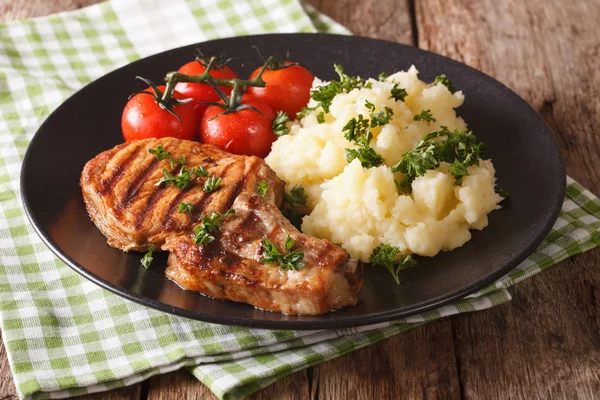 Grilled pork T-bone steak garnished with mashed potatoes close-u — Stock Photo, Image