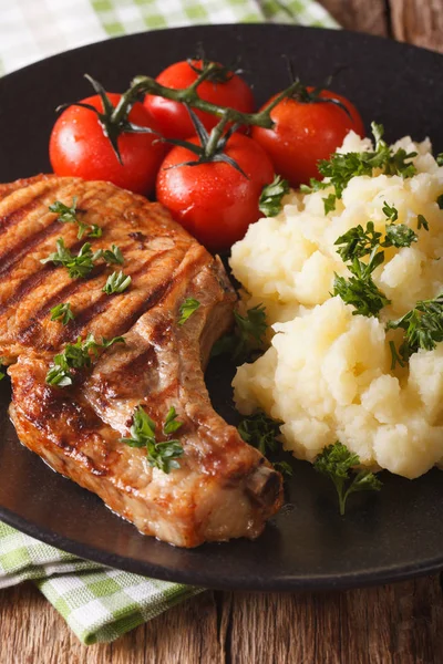 Grilled pork chop with mashed potatoes close-up. vertical — Stock Photo, Image