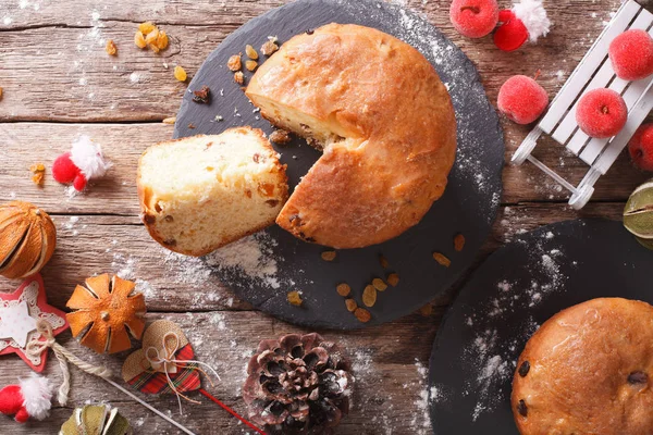 Christmas panettone bread with dried fruit and festive decoratio — Stock Photo, Image