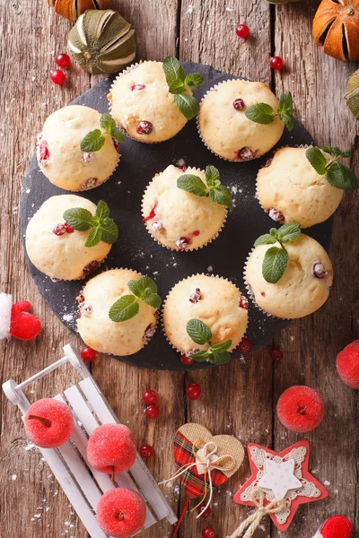 cranberry muffins with mint and Christmas decoration close-up. v