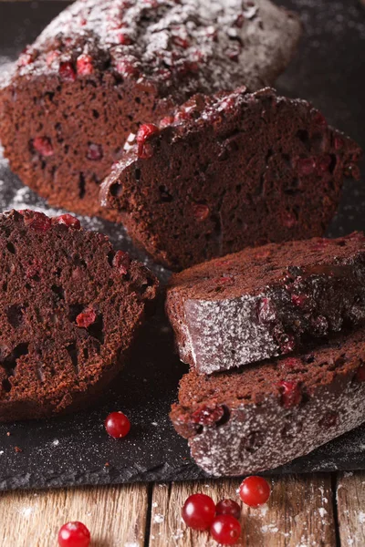 Sliced chocolate pie stuffed with cranberries macro. vertical — Stock Photo, Image