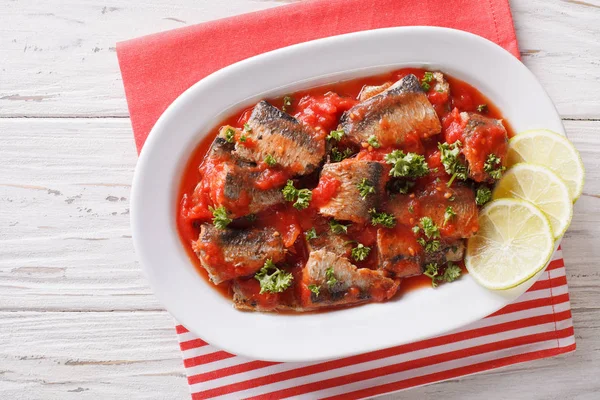 Sardines in tomato sauce, decorated with lime and parsley close- — Stock Photo, Image