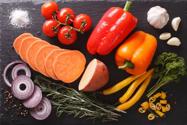 Raw sweet potatoes, peppers, tomatoes, onions, garlic, rosemary — Stock Photo, Image