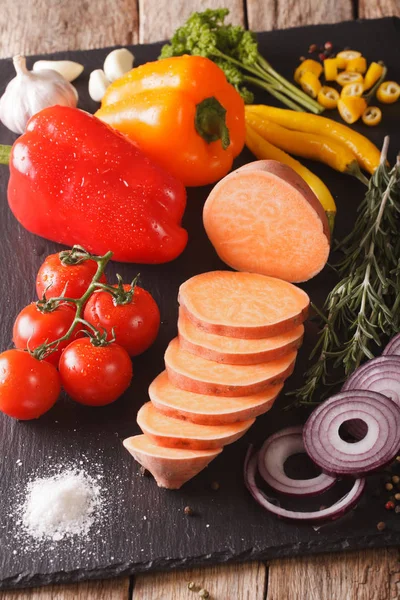 Raw sweet potatoes, peppers, tomatoes, onions, garlic, rosemary — Stock Photo, Image