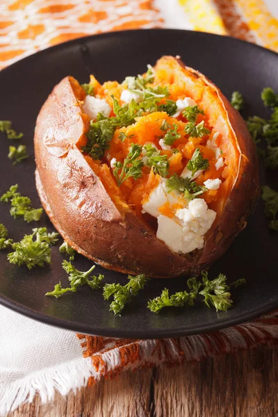 Whole sweet potato baked with cheese, spices and parsley close-u — Stock Photo, Image