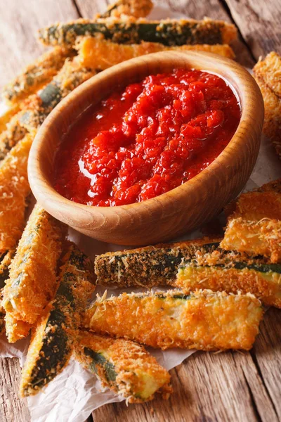 Fried zucchini sticks in breading and tomato sauce closeup. vert — Stock Photo, Image