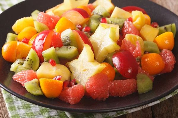 Fruit salad with orange, kumquat, pineapple, carambola, grapefru — Stock Photo, Image