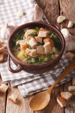 Traditional soup with garlic and croutons close-up. vertical