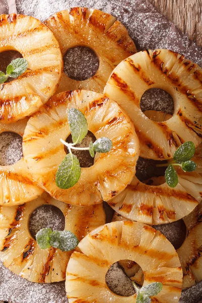 Homemade grilled pineapple on the paper close-up. vertical top v — Stock Photo, Image