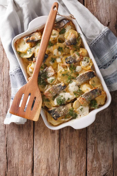 Finnish Food: Casserole with potatoes and herring close up in ba — Stock Photo, Image