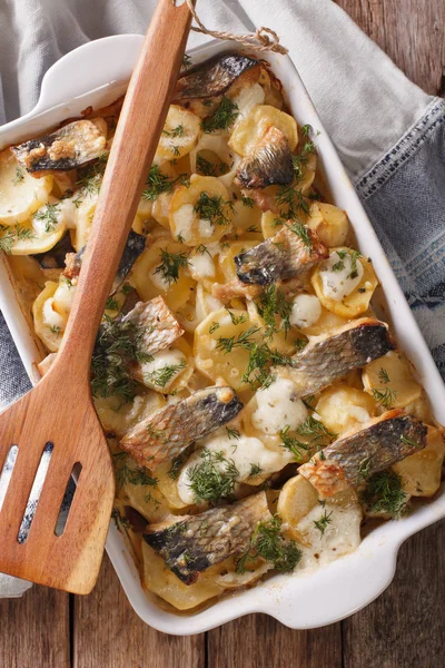 Finnish Food: Casserole with potatoes and herring close up in ba — Stock Photo, Image