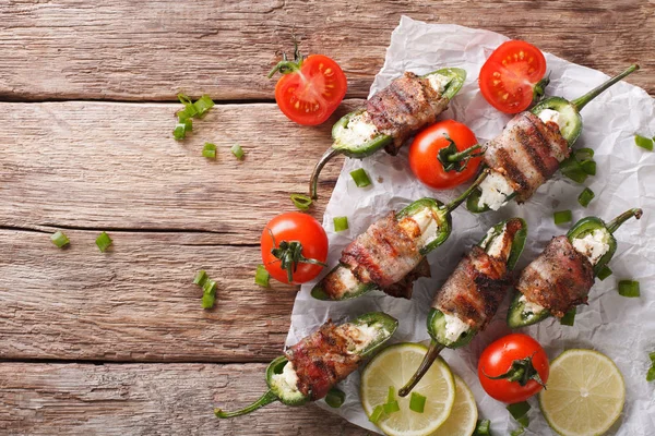 Baked Jalapeno pepper with feta cheese wrapped in bacon close-up — Stock Photo, Image