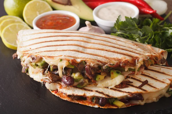 Mexican food: Quesadillas with beef, beans, avocado and cheese c