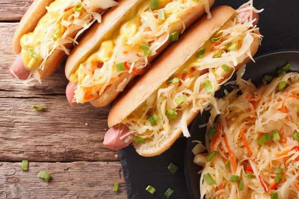 Tasty sandwich with sausage, sauerkraut and mustard close up. ho — Stock Photo, Image