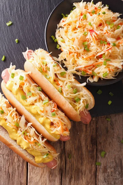 Delicious hot dog with sausage, sour cabbage and mustard close-u — Stock Photo, Image