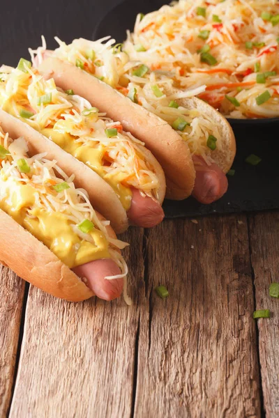 Hot dog with sauerkraut and mustard close up. vertical — Stock Photo, Image