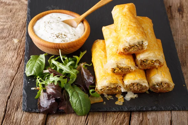 Crispy rolls borek with minced meat and eggs close-up on the tab — Stock Photo, Image
