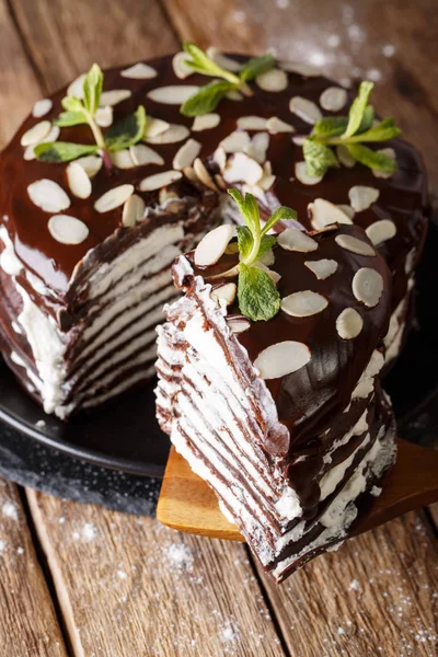 Piece of chocolate crepe cake with whipped cream and almonds clo — Stock Photo, Image