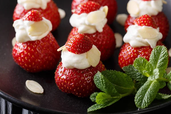 Organic strawberry stuffed with whipped cream, almonds and mint — Stock Photo, Image