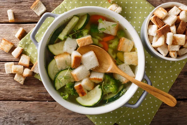 Delicious bread soup with zucchini and greens close-up in a bowl — Stock Photo, Image