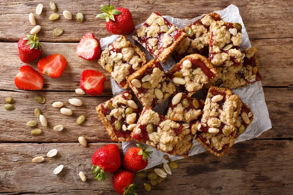 Homemade strawberry bars with oatmeal, peanuts and pumpkin seeds