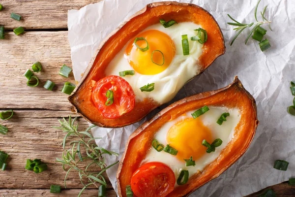 Baked yam filling with egg and tomato close-up on the table. Hor — Stock Photo, Image