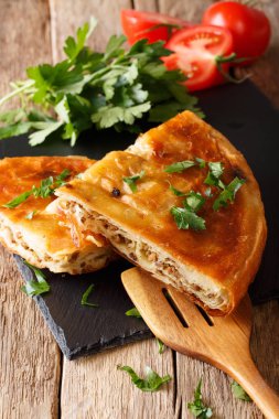 Homemade sliced burek stuffed with meat close-up. vertical clipart