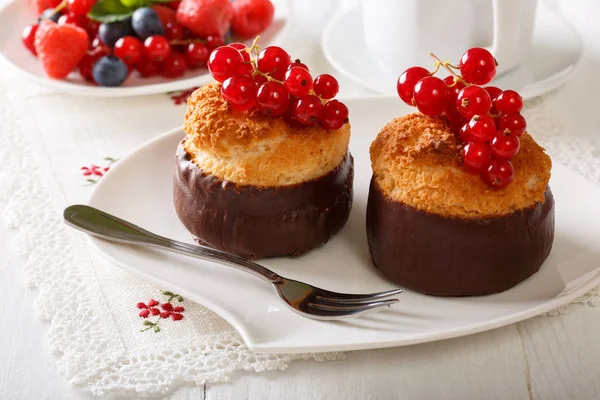 Beautiful chocolate coconut muffins with currant close-up. horiz — Stock Photo, Image
