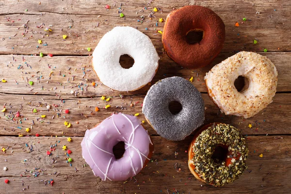 Multicolored donuts with fillings close-up on the table. horizon — Stock Photo, Image