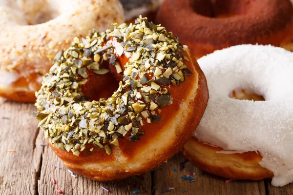 Beautiful donuts with sunflower seeds and coconut macro on the t — Stock Photo, Image