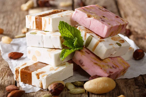 White, pink and brown nougat with nuts and mint closeup. Horizon — Stock Photo, Image