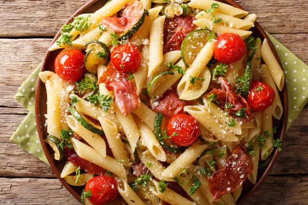 Pasta penne with fried ham, cherry tomatoes, zucchini and cheese — Stock Photo, Image