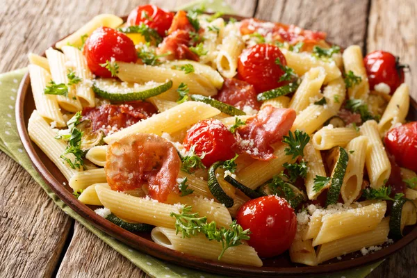 Pasta penne with fried ham, cherry tomatoes, zucchini and cheese — Stock Photo, Image